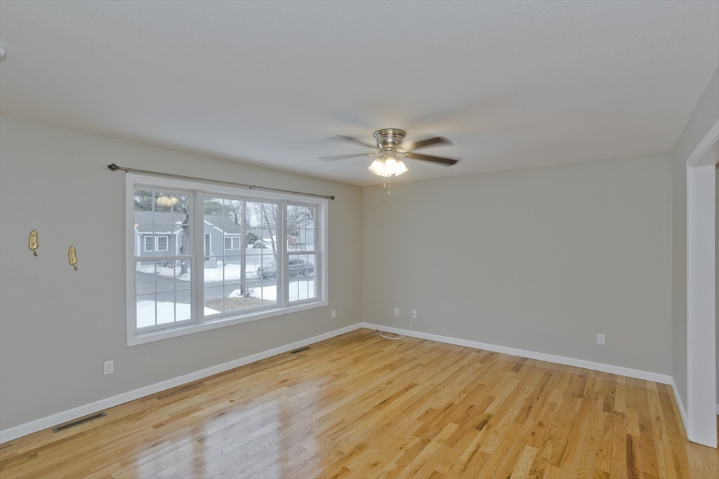 239 Gresham Street Springfield, MA 01119 - Photo 17 of 39 a view of an empty room with wooden floor and a window