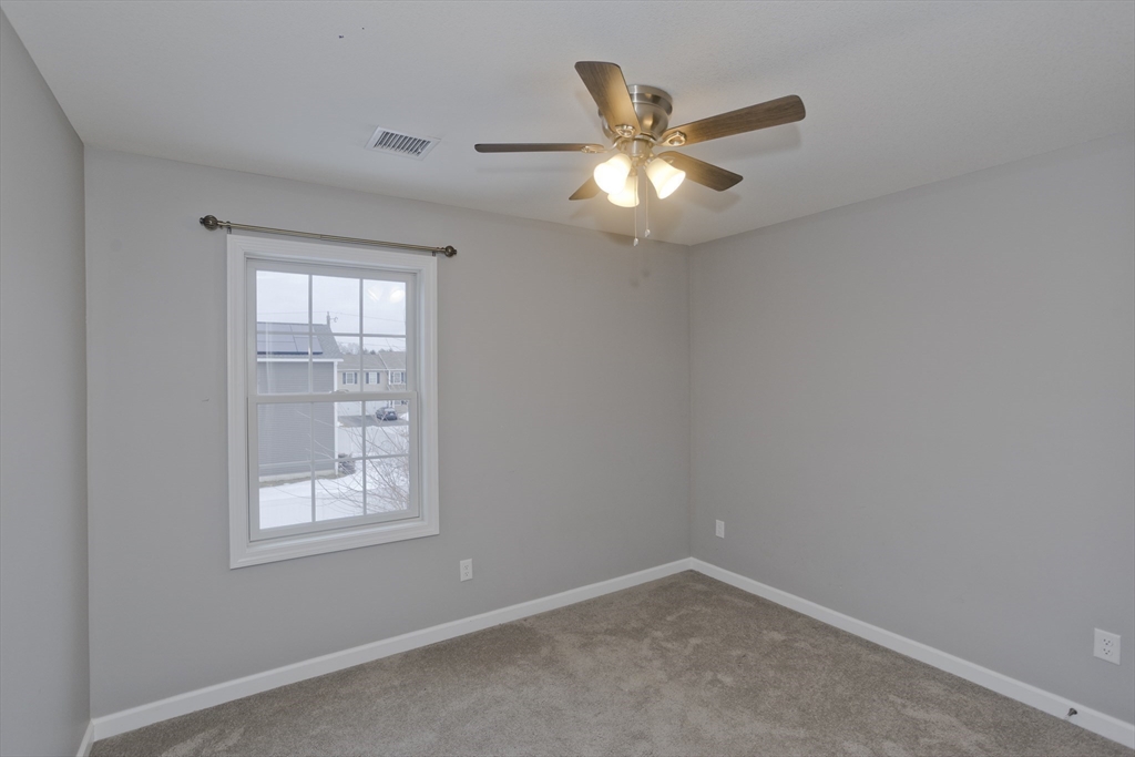 239 Gresham Street Springfield, MA 01119 - Photo 23 of 39 an empty room with windows and fan