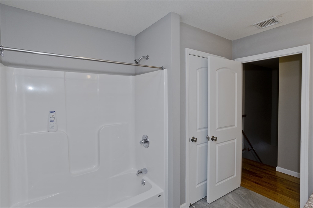 239 Gresham Street Springfield, MA 01119 - Photo 27 of 39 a bathroom with a glass shower door