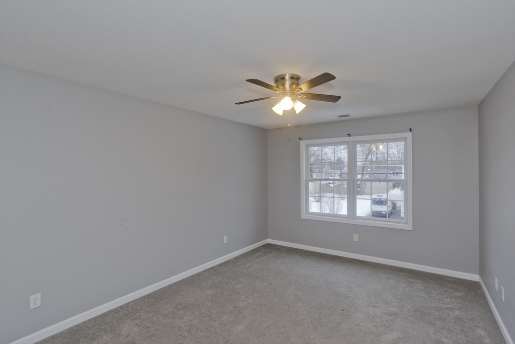 239 Gresham Street Springfield, MA 01119 - Photo 28 of 39 an empty room with a window and a ceiling fan