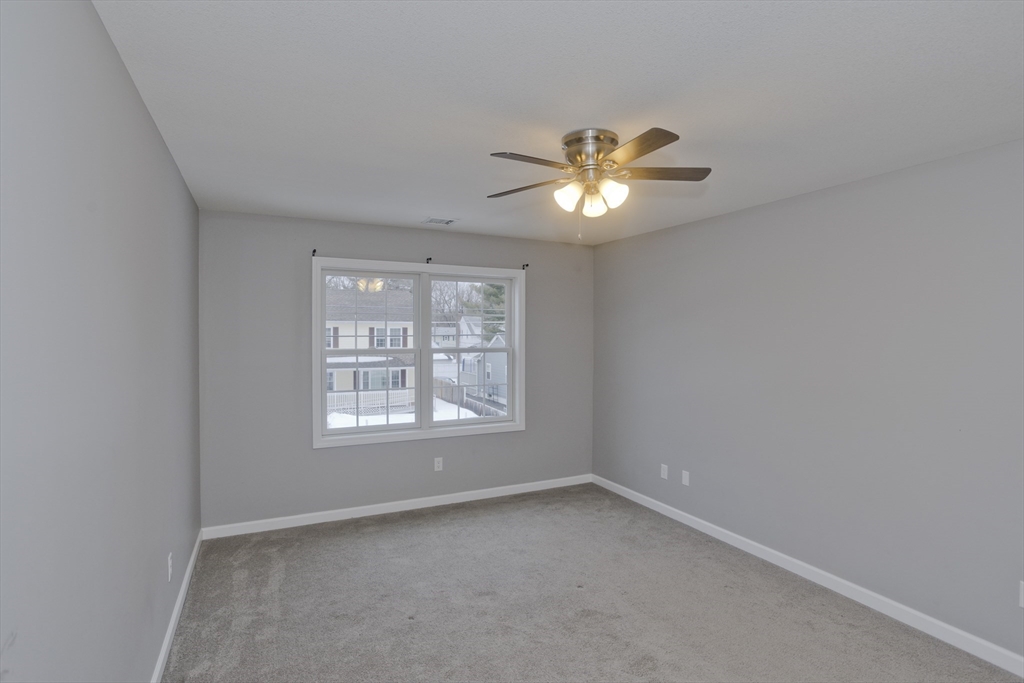239 Gresham Street Springfield, MA 01119 - Photo 29 of 39 an empty room with a window and a ceiling fan