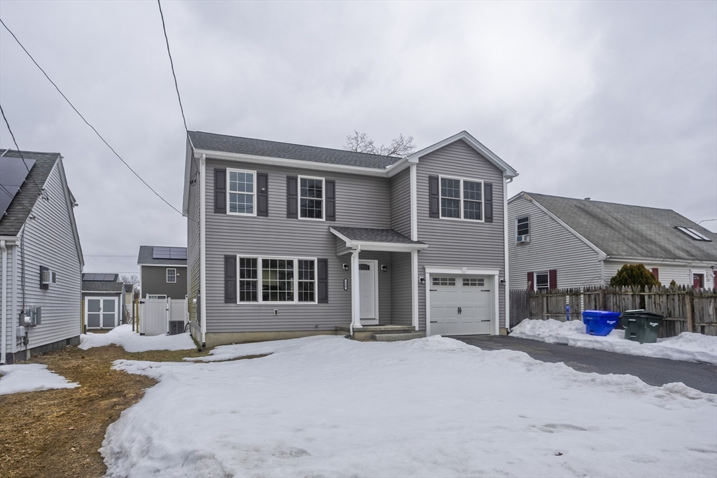 239 Gresham Street Springfield, MA 01119 - Photo 3 of 39 a front view of a house with a yard