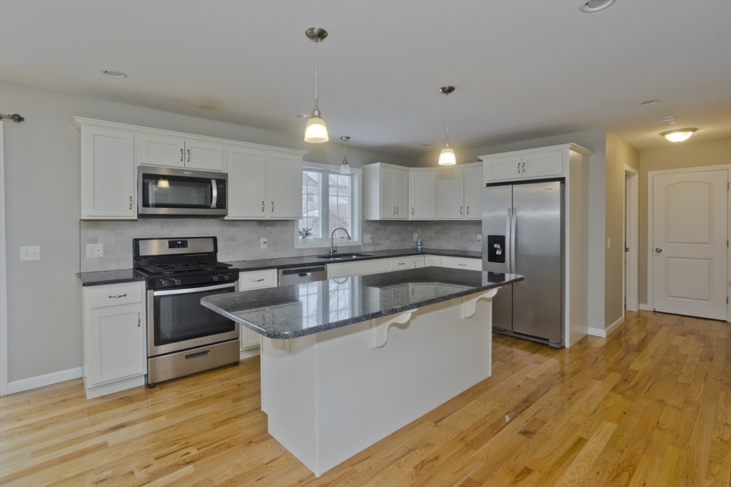 239 Gresham Street Springfield, MA 01119 - Photo 5 of 39 a kitchen with stainless steel appliances granite countertop a stove a sink and a refrigerator
