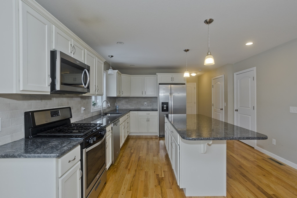 239 Gresham Street Springfield, MA 01119 - Photo 8 of 39 a kitchen with granite countertop a sink stainless steel appliances and cabinets