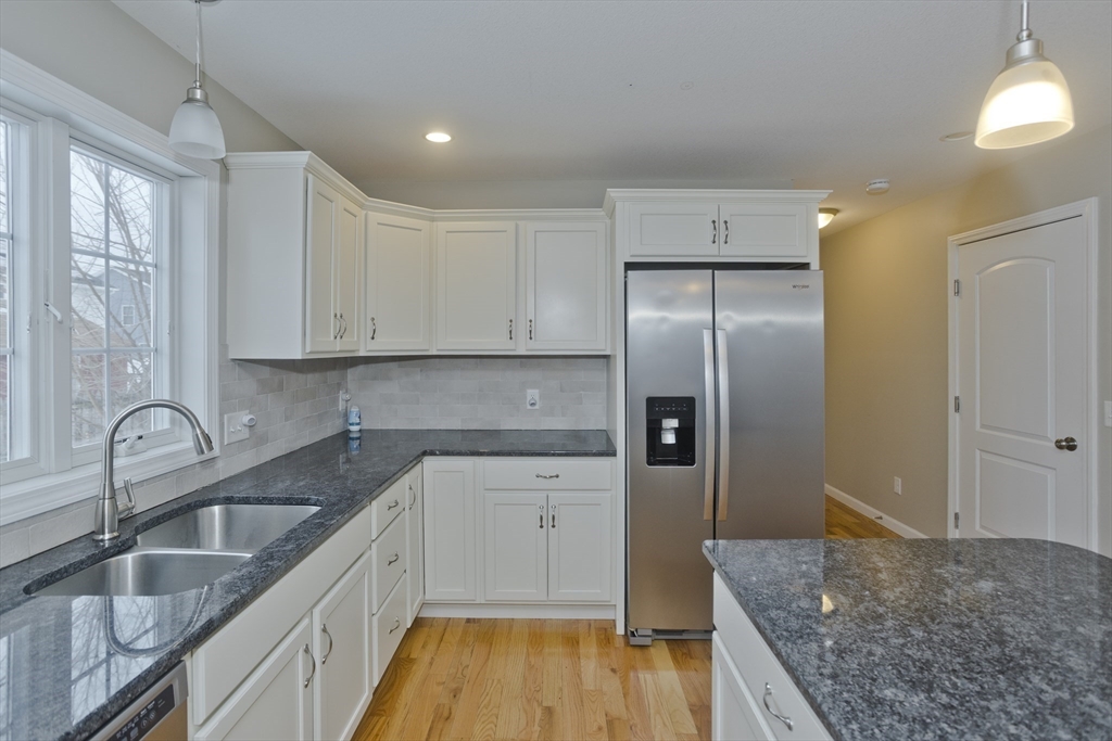 239 Gresham Street Springfield, MA 01119 - Photo 9 of 39 a kitchen with granite countertop a sink stove and refrigerator