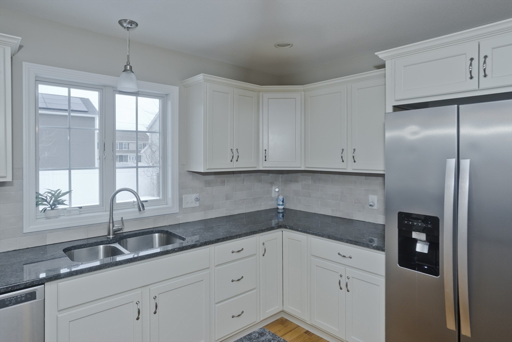 239 Gresham Street Springfield, MA 01119 - Photo 10 of 39 a kitchen with granite countertop white cabinets and white appliances