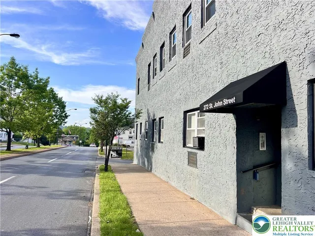 a pathway of a house with a yard