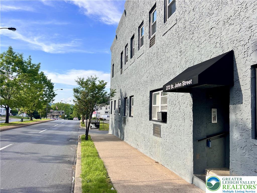 a pathway of a house with a yard