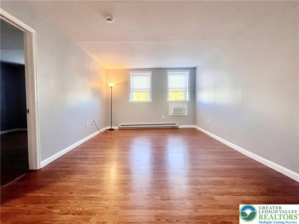 272 St John Street, Unit 5 Easton, PA 18042 - Photo 5 of 9 an empty room with wooden floor and windows