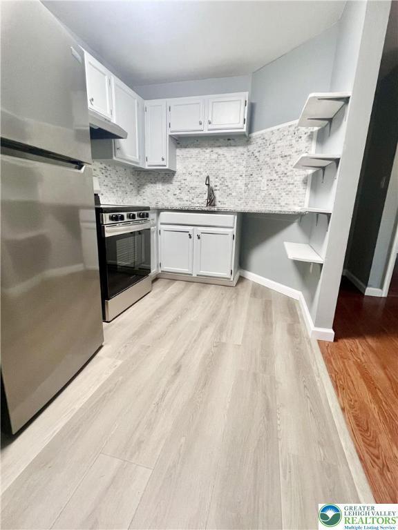 272 St John Street, Unit 5 Easton, PA 18042 - Photo 6 of 9 a kitchen with granite countertop a sink stainless steel appliances and cabinets