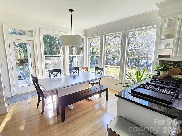 a living room with furniture and large windows