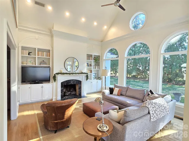 a living room with furniture a fireplace and a flat screen tv