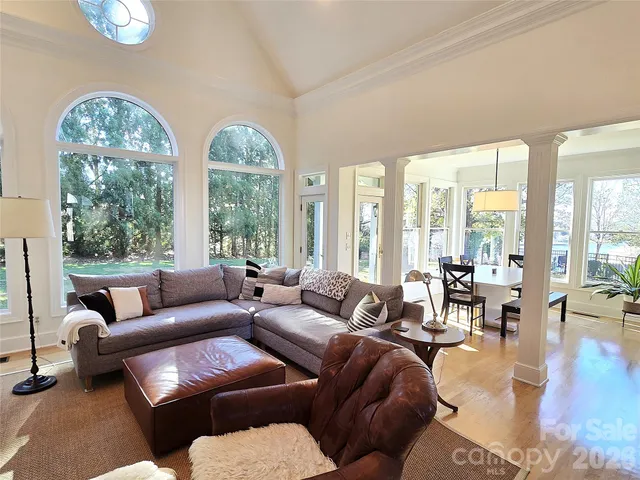 a living room with furniture and floor to ceiling windows