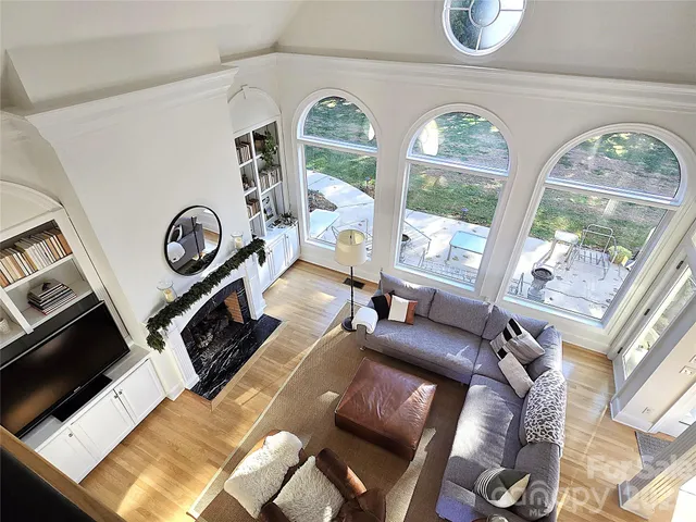 a living room with furniture fireplace and a large window