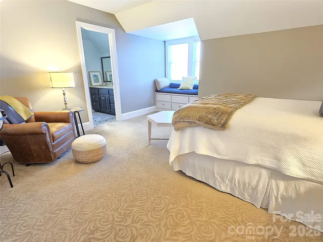 a spacious bedroom with a bed and window