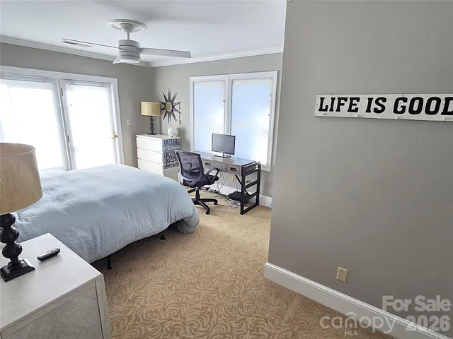 a bedroom with a bed and a chandelier