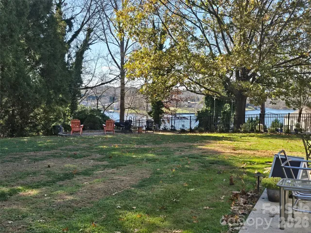a swimming pool with outdoor seating and yard