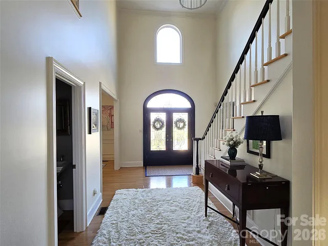 a living room with furniture and a mirror
