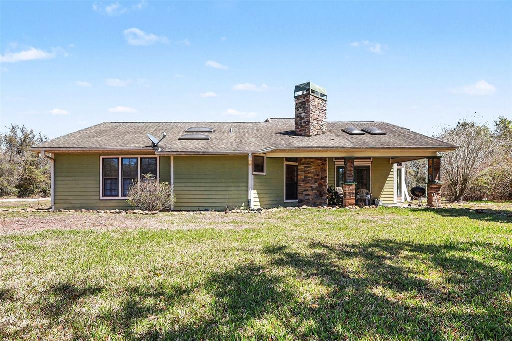 58 Deer Road Frostproof, FL 33843 - Photo 16 of 20 a front view of a house with a garden and porch