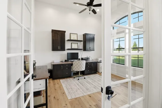 a bathroom with a granite countertop sink a mirror and shower