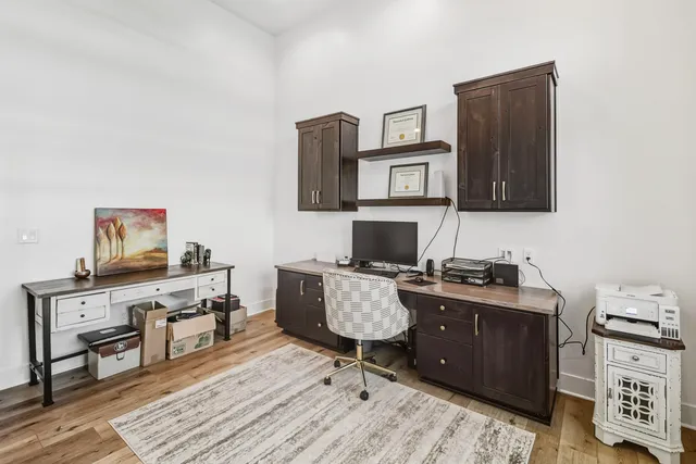 a kitchen with stainless steel appliances granite countertop a refrigerator and a wooden cabinets