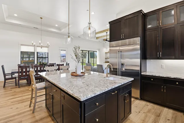 a spacious bedroom with a large bed and a chandelier
