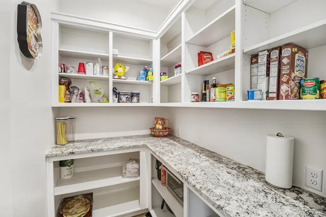 a living room with furniture and floor to ceiling windows