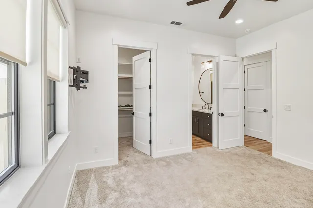 a view of an empty room with a ceiling fan