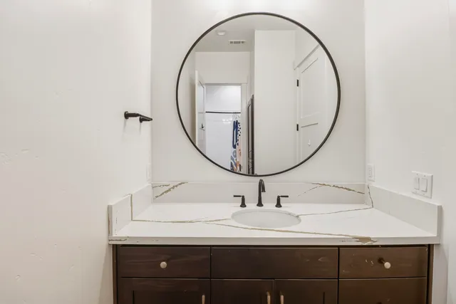 an empty room with a ceiling fan and a window