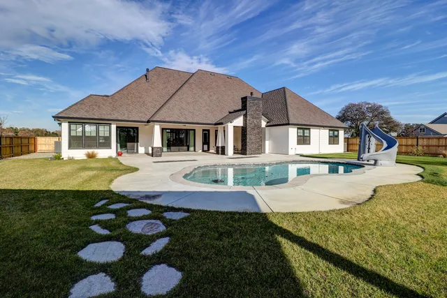 a aerial view of a house next to a yard