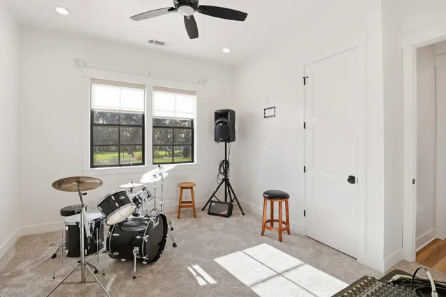 a living room with furniture a ceiling fan and a window