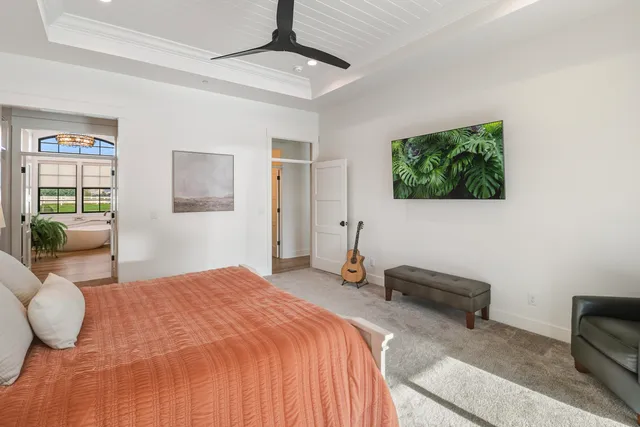 a view of a house with a yard and large tree