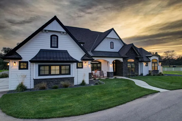 an aerial view of a house with garden space and lake view