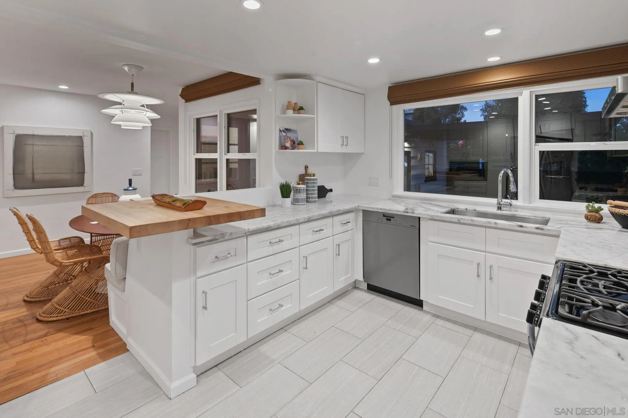 211 Ocean Street Solana Beach, CA 92075 - Photo 14 of 29 a kitchen with a sink stove and cabinets