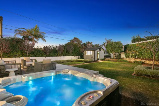 a view of yard with swimming pool and seating