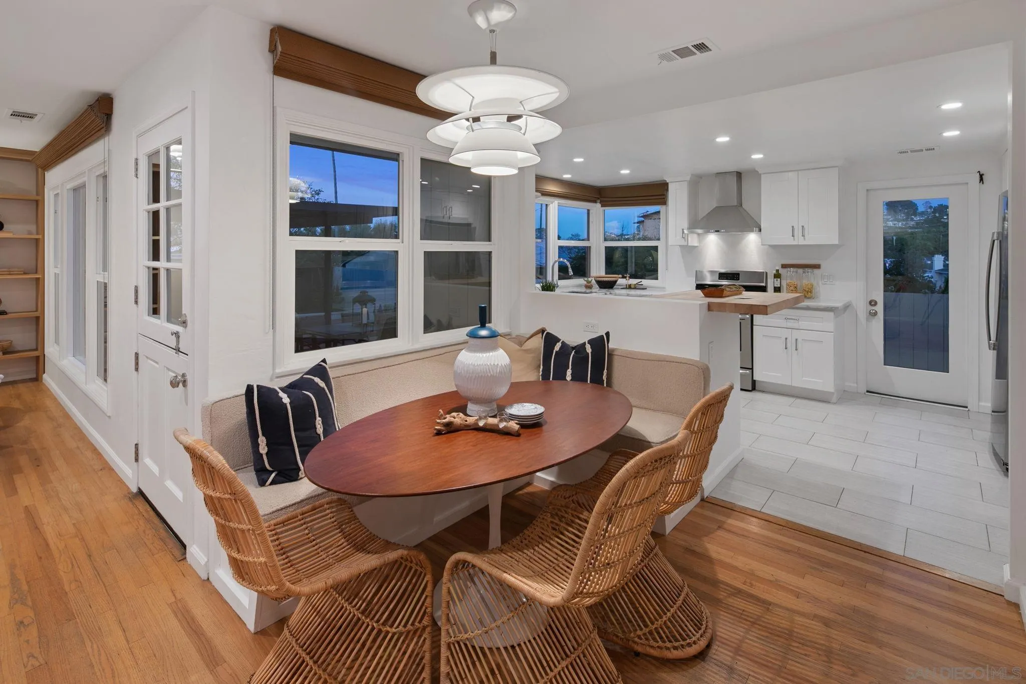 211 Ocean Street Solana Beach, CA 92075 - Photo 8 of 29 a dining room with stainless steel appliances kitchen island granite countertop a table chairs and a refrigerator