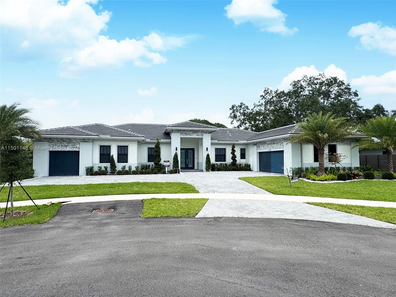 11172 Southwest 91 Avenue Miami, FL 33176 - Photo 1 of 12 a front view of a house with a yard and trees