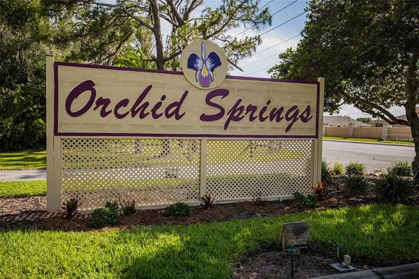a view of a sign under a tree