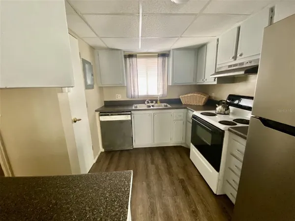 a kitchen with stainless steel appliances a stove a sink and a refrigerator