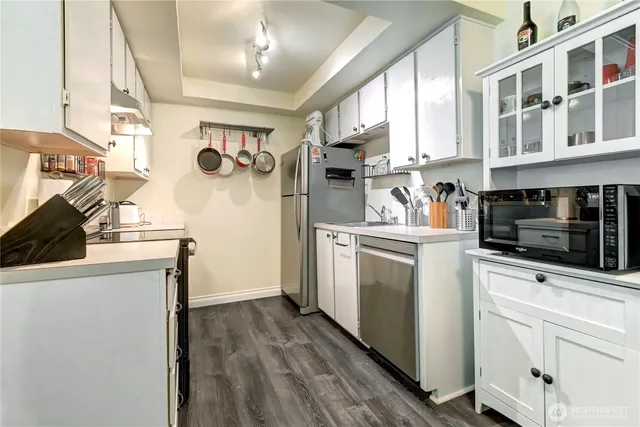 a kitchen with a refrigerator a stove a microwave and cabinets