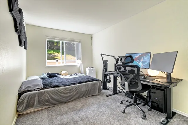 a bedroom with a bed and a desk