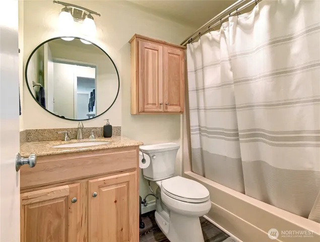a bathroom with a sink a toilet and a mirror