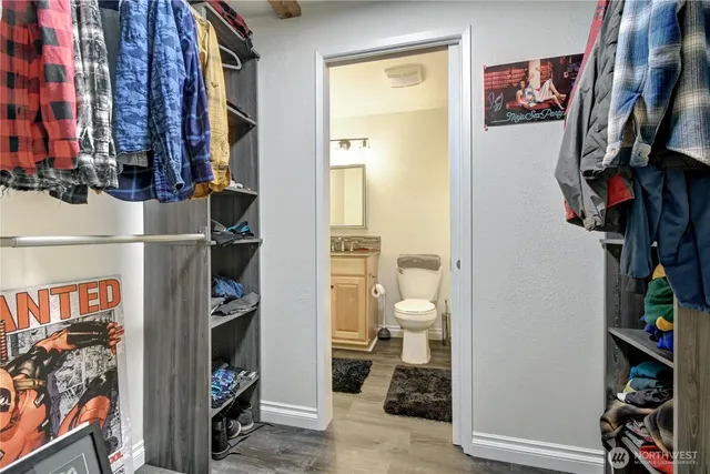 a view of walk in closet with clothes and shoes