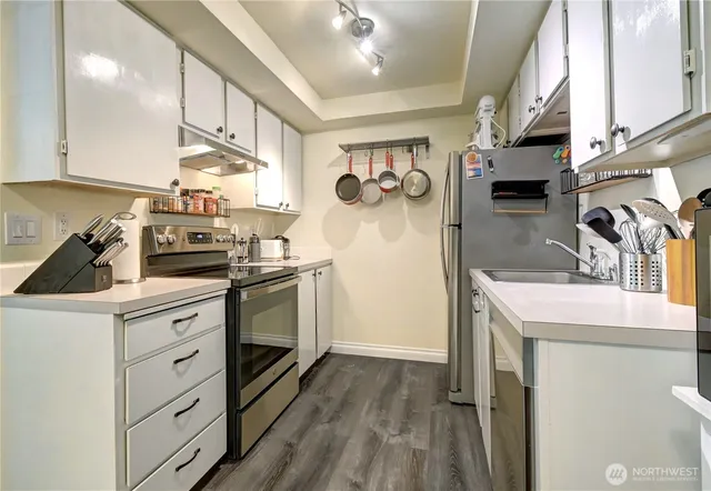 a kitchen with a sink a stove and cabinets