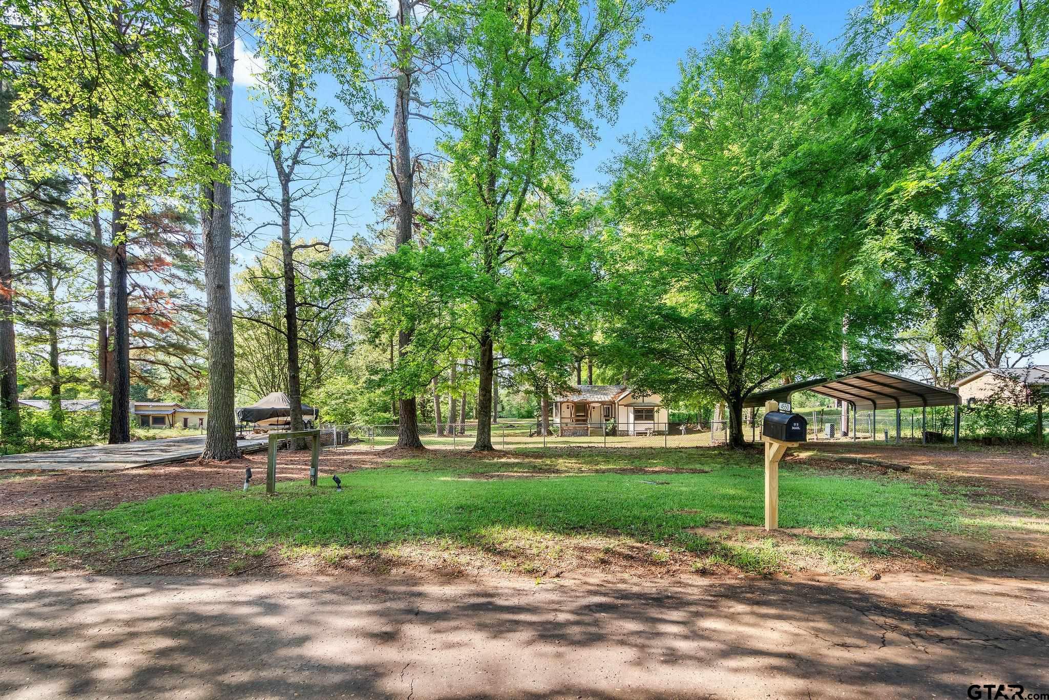 4550 Crabapple Road Gilmer, TX 75645 - Photo 25 of 33 a garden with trees in the background