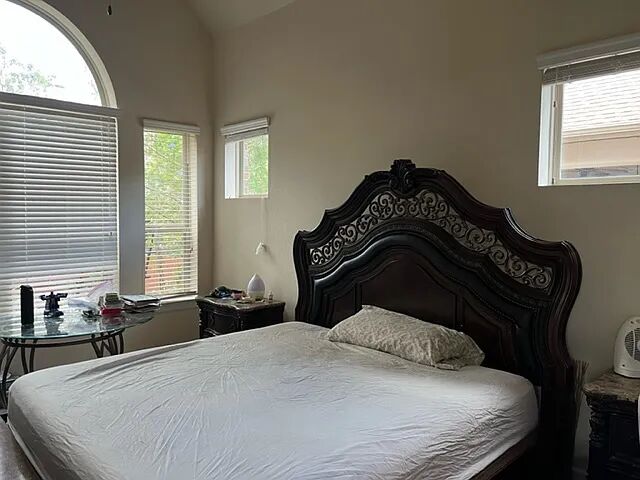 a bedroom with a bed and a window