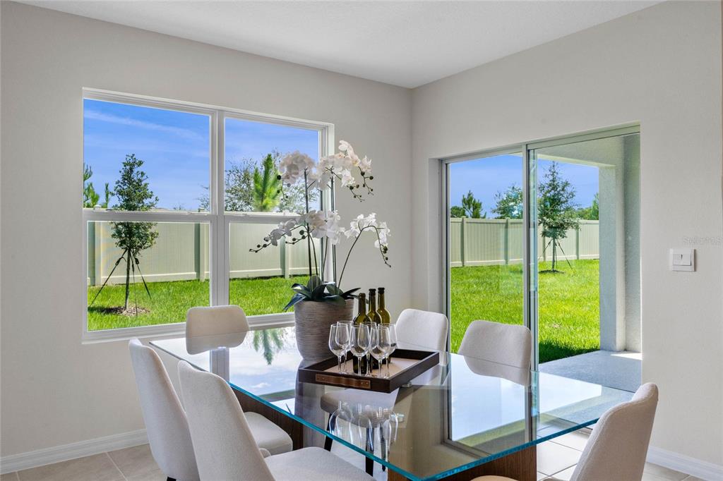 3503 Nettle Loop Tavares, FL 32778 - Photo 15 of 38 a dining room with furniture a garden and mountain view