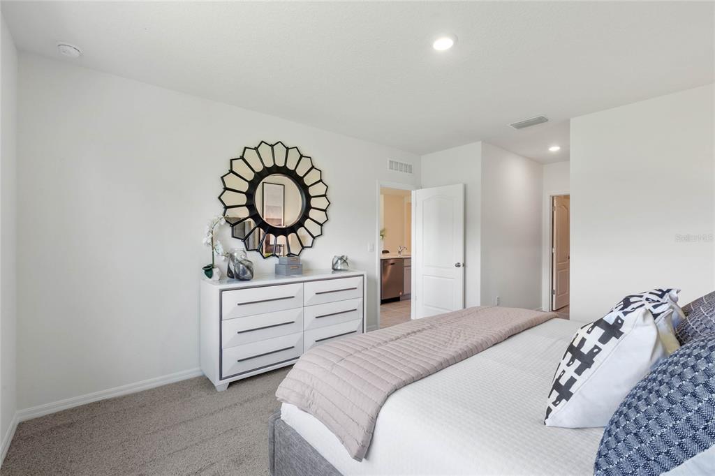 3503 Nettle Loop Tavares, FL 32778 - Photo 24 of 38 a bedroom with a bed and a dresser