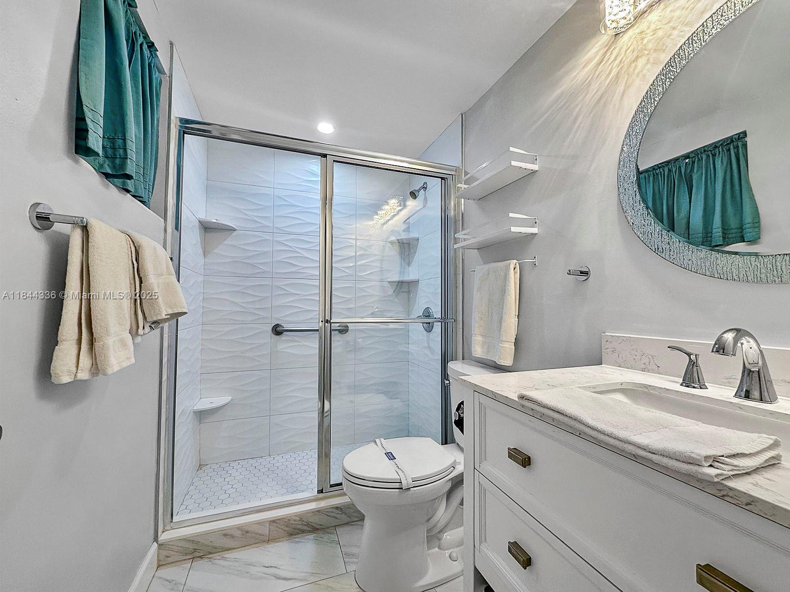 555 North Riverside Drive, Unit 4 Pompano Beach, FL 33062 - Photo 14 of 22 a bathroom with a toilet sink and shower