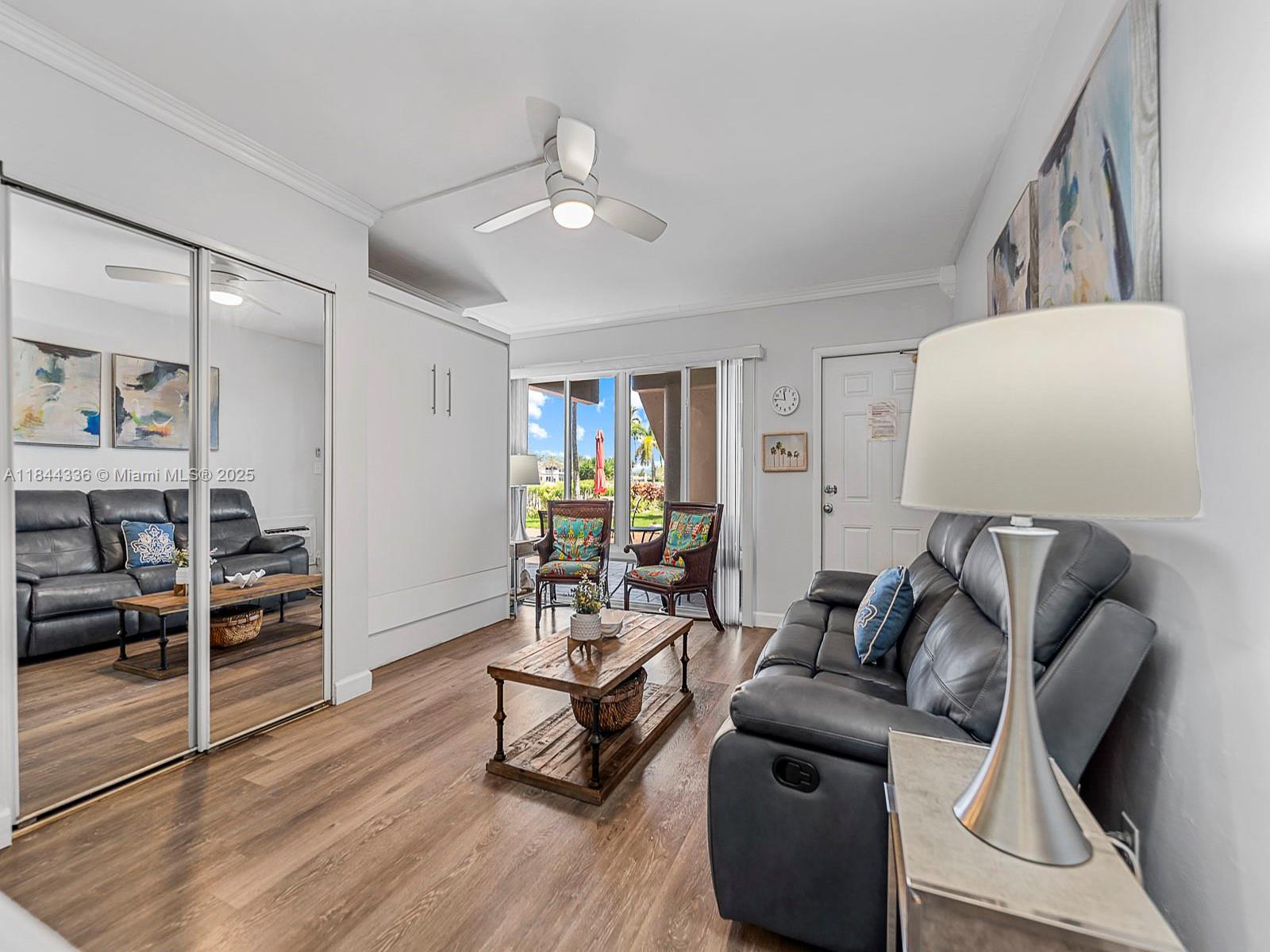 555 North Riverside Drive, Unit 4 Pompano Beach, FL 33062 - Photo 8 of 22 a living room with furniture and a wooden floor